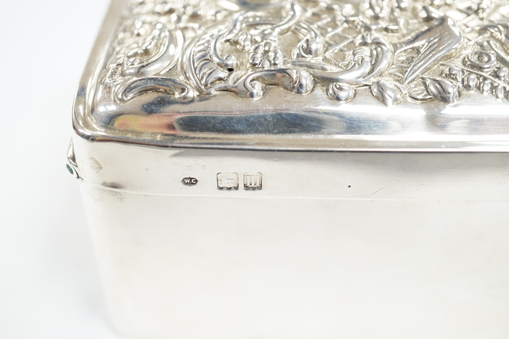 An Edwardian silver trinket box, with repousse hinged cover, William Comyns, London, 1907, 11cm. Condition - poor to fair